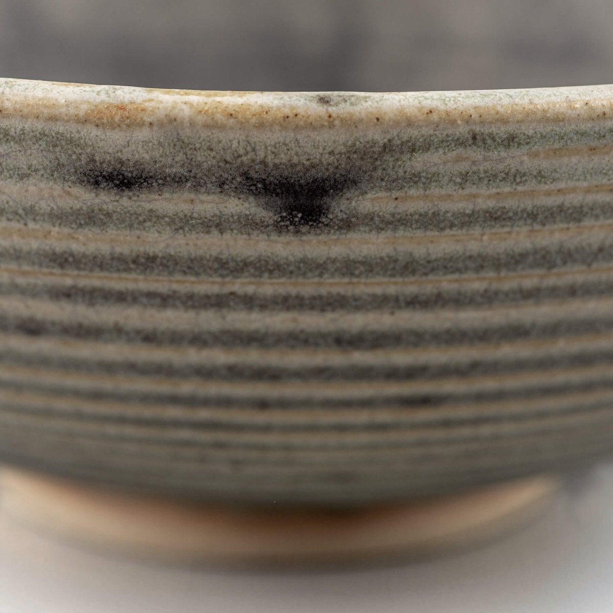 Stoneware bowl with glazed interior and raw textured exterior, suitable for serving or as a centerpiece decor item.