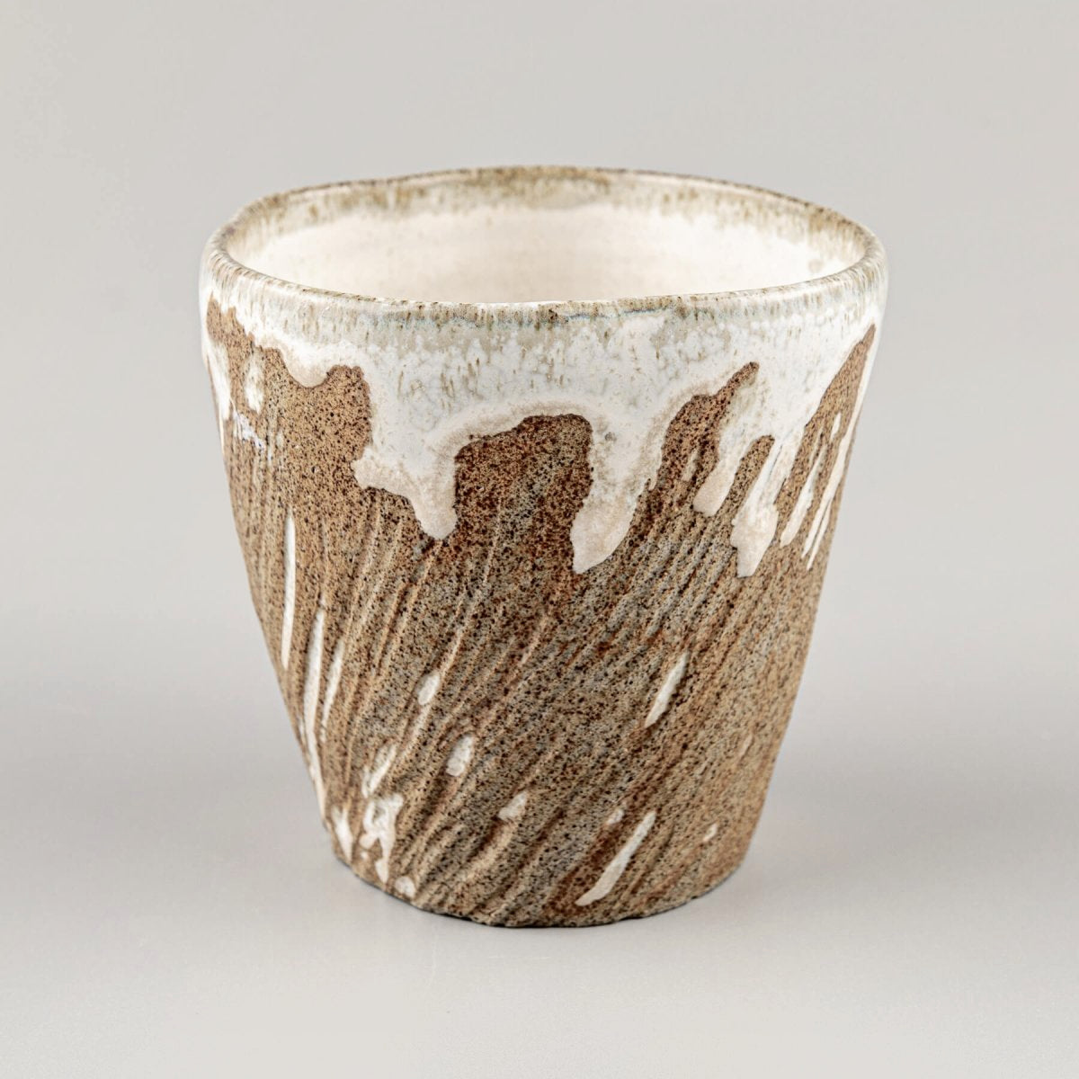 Ceramic espresso mugs with carved texture and earthy brown stoneware finish.