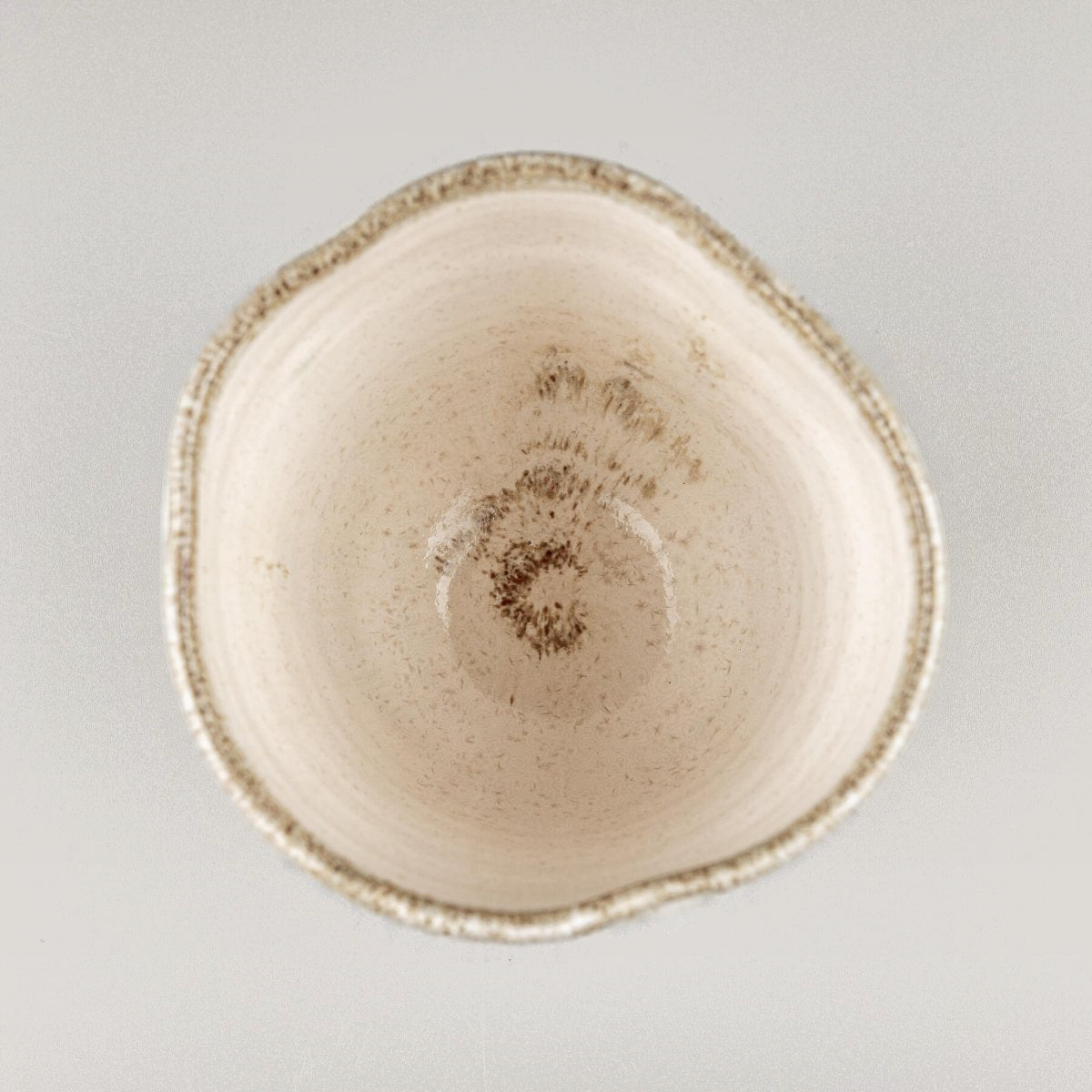 Top view of ceramic espresso mug with glazed interior and smooth rim.