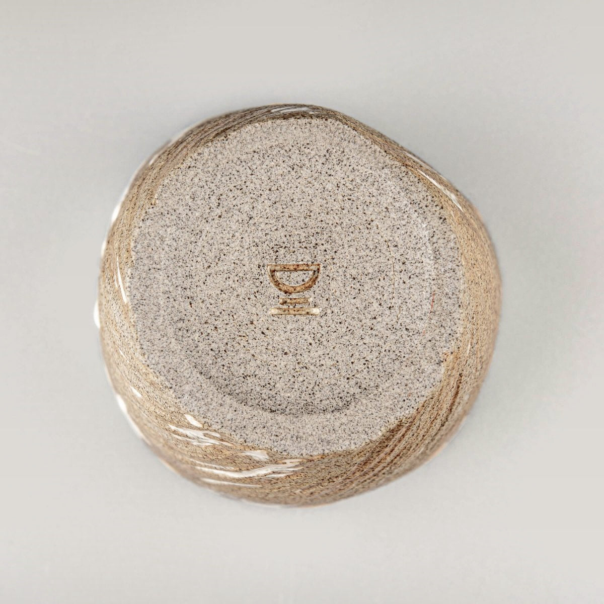 Bottom view of ceramic espresso mug showing handcrafted base detail.