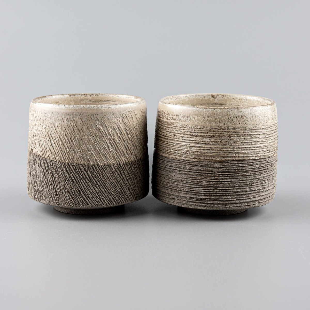 Rustic pottery coffee mugs with artistic carving, ideal for home, boutique hotel, or fine dining use.