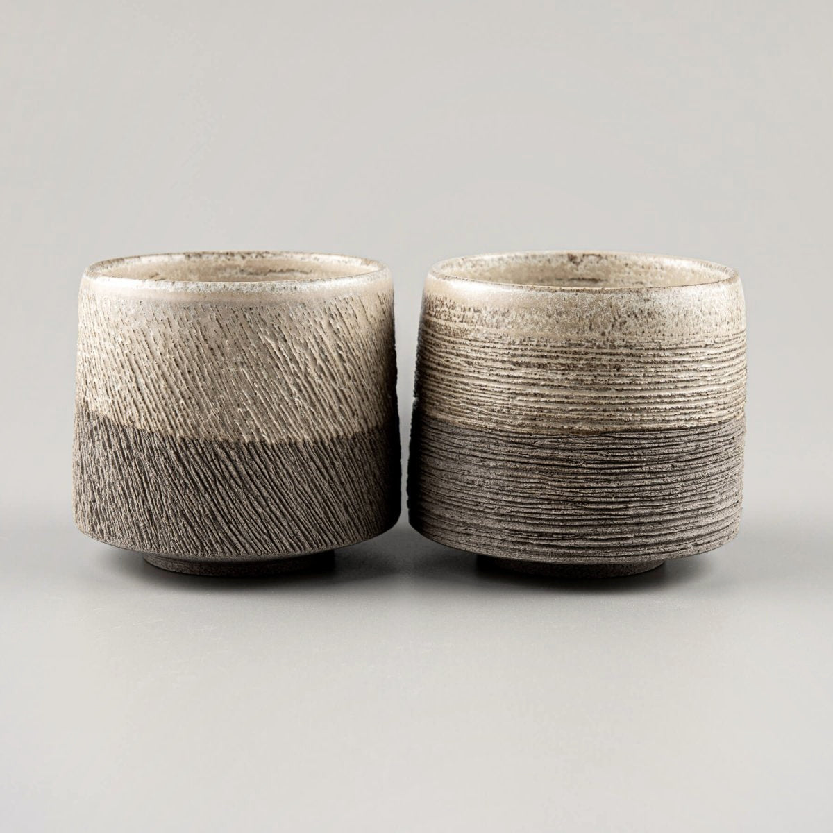 Rustic pottery coffee mugs with artistic carving, ideal for home, boutique hotel, or fine dining use.