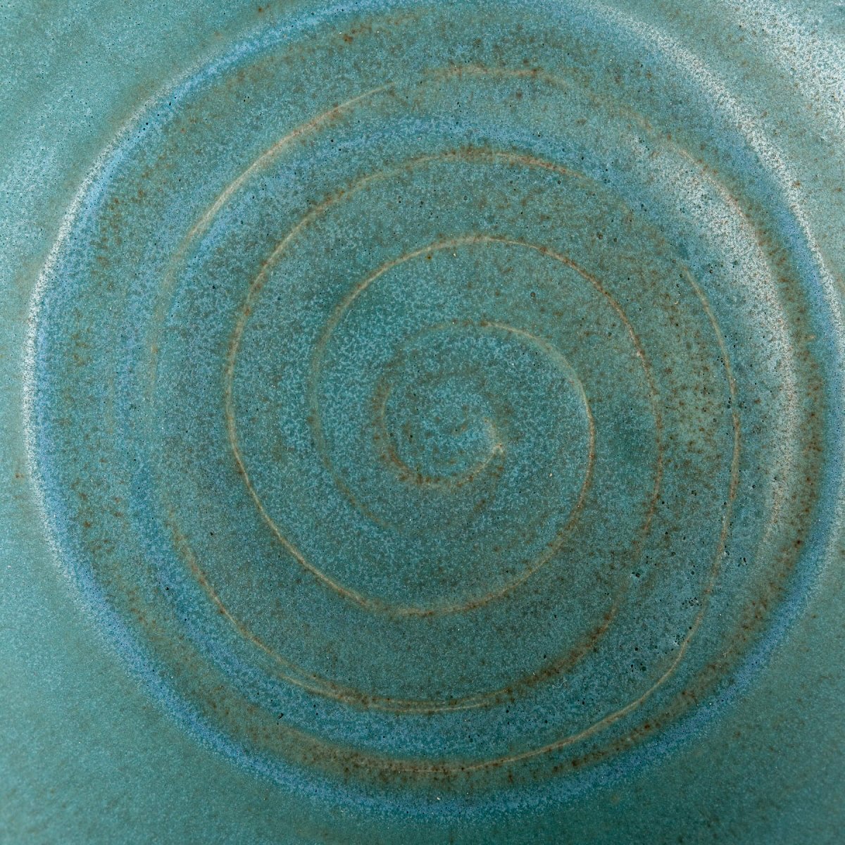 Artisan stoneware vase with textured exterior and turquoise glaze, perfect for interior decoration.