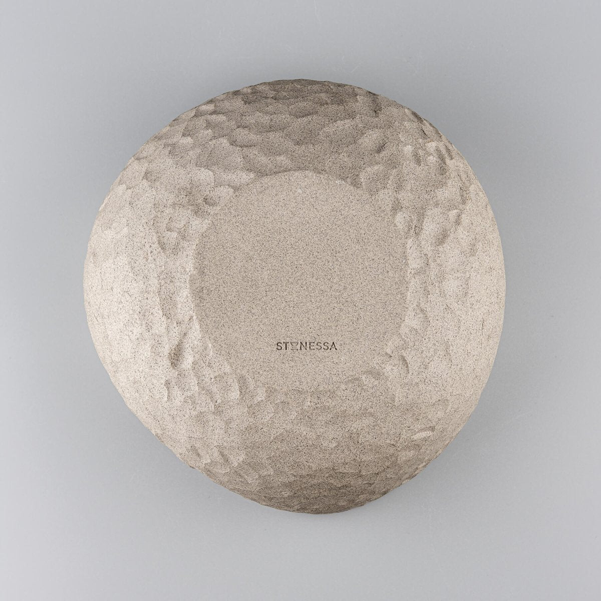 Bottom view of a handmade stoneware vase showing a textured ceramic surface for interior design.