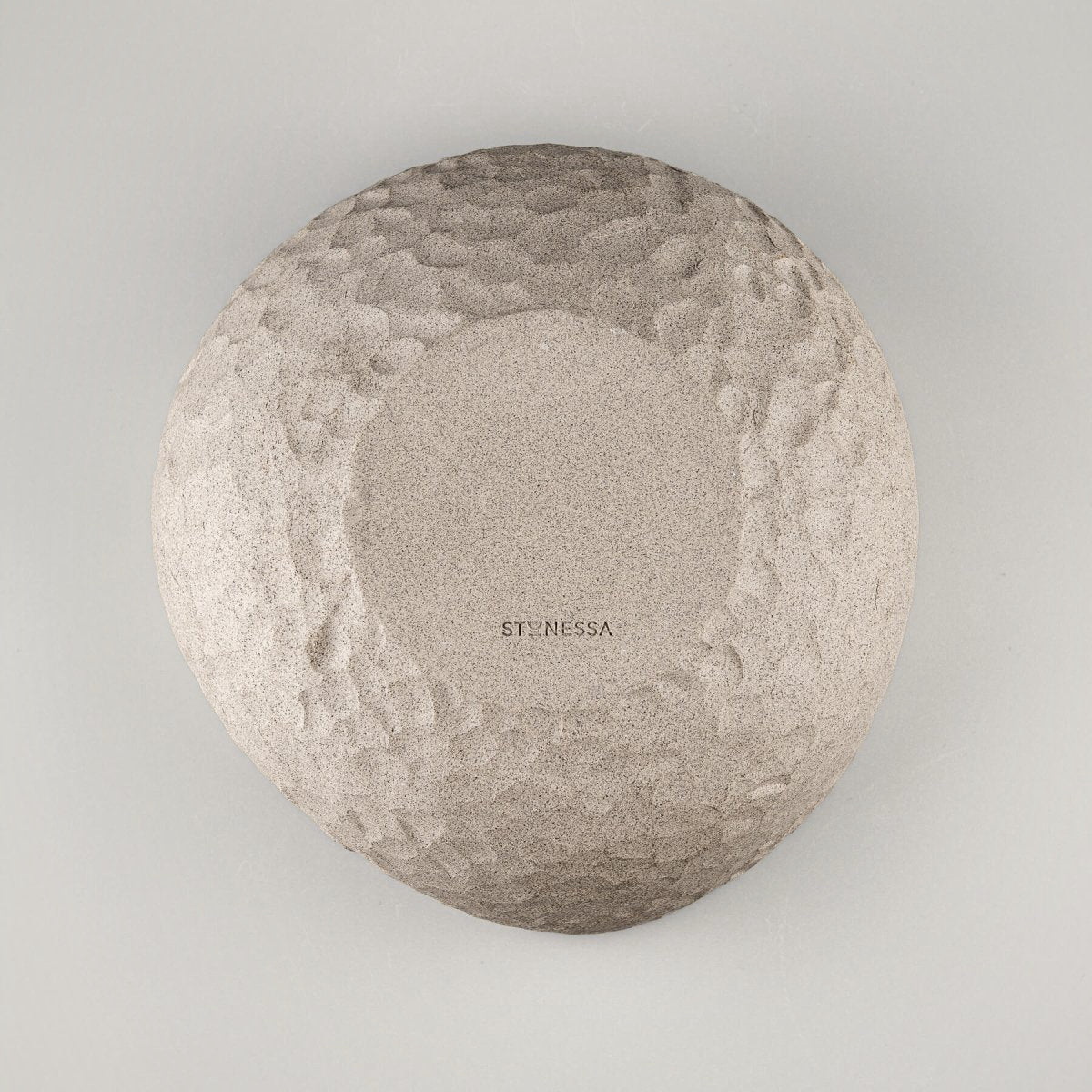Bottom view of a handmade stoneware vase showing a textured ceramic surface for interior design.
