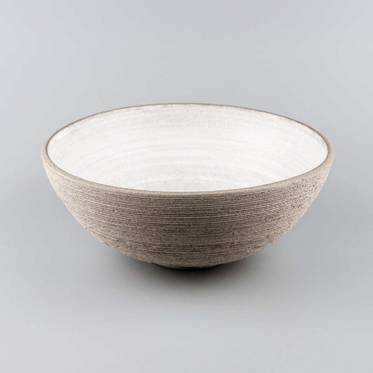 Elegant ceramic bowl in use, highlighting its size and design for restaurants and decorative settings.