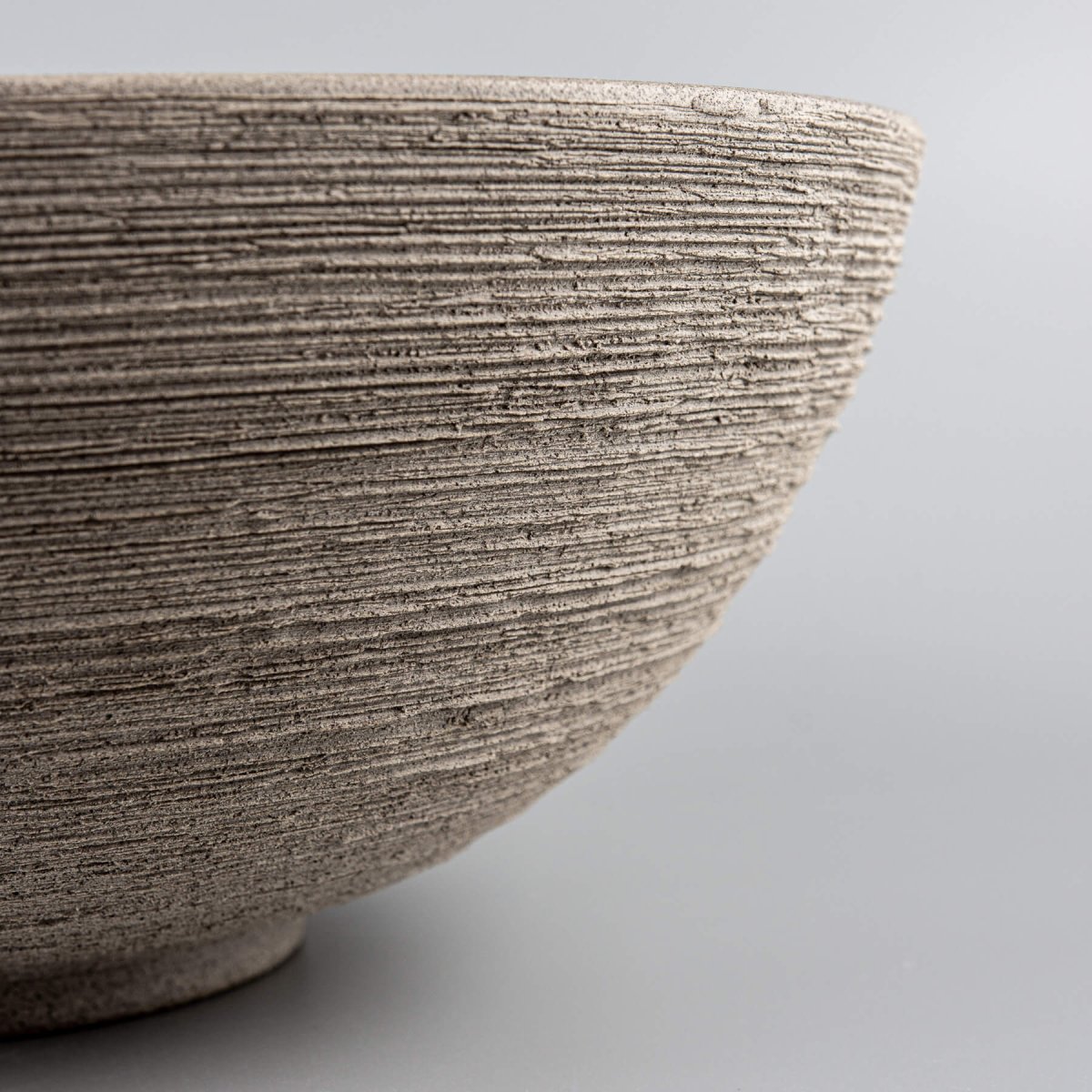 Profile view showing the seamless transition from the beveled rim to the curved base of the bowl.