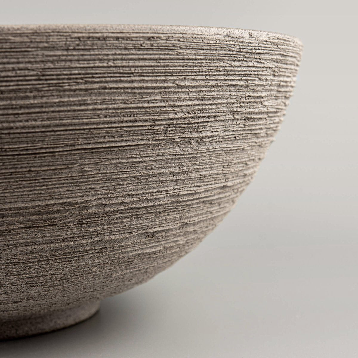 Profile view showing the seamless transition from the beveled rim to the curved base of the bowl.
