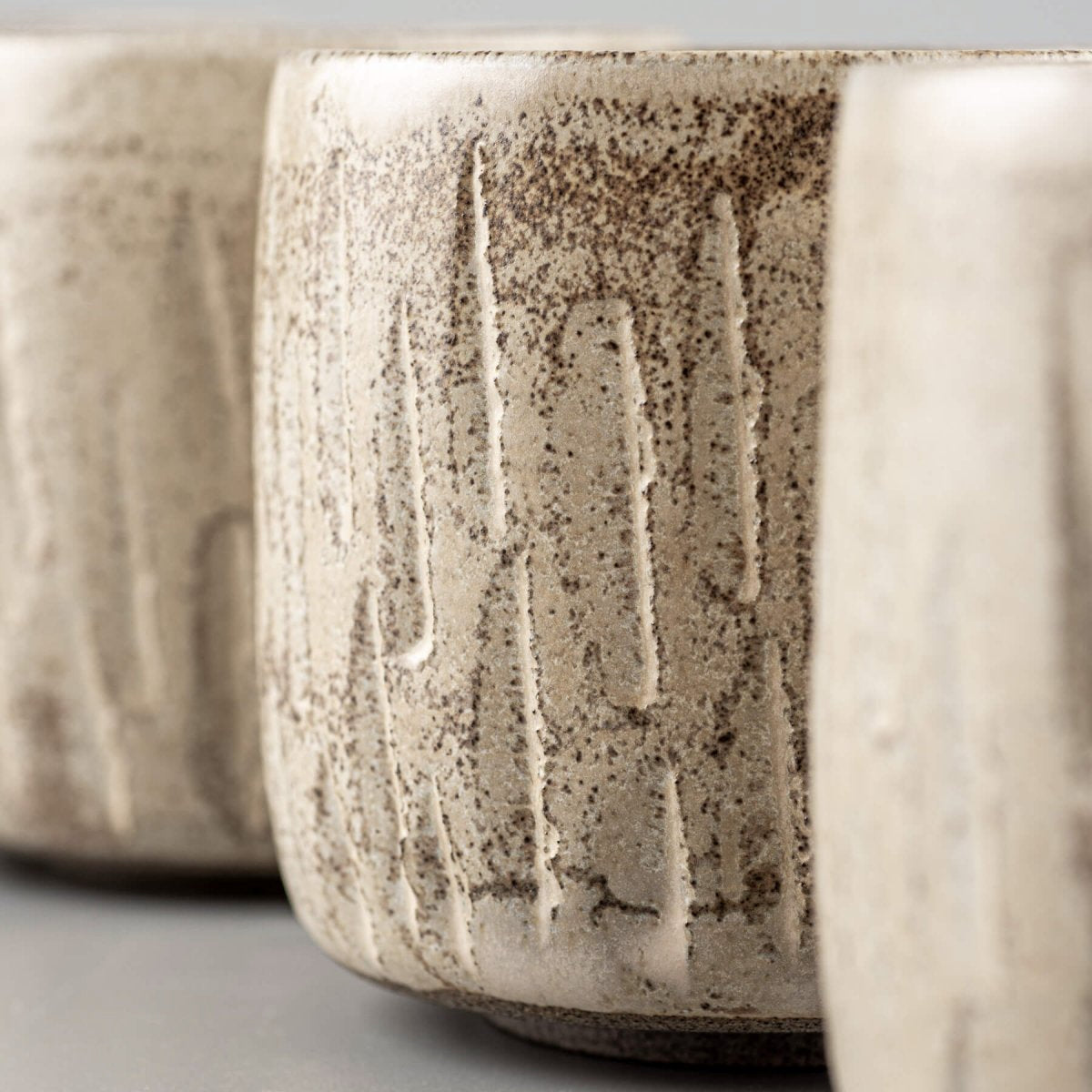 Detailed rim texture of ceramic handmade cup with rustic carved surface.