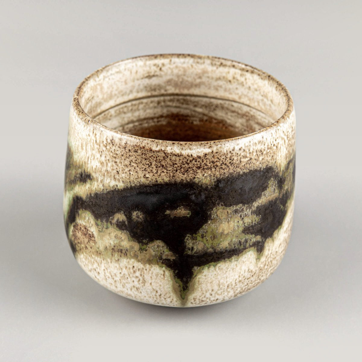 Luxury artisanal stoneware mugs with earthy tones and organic glaze design.
