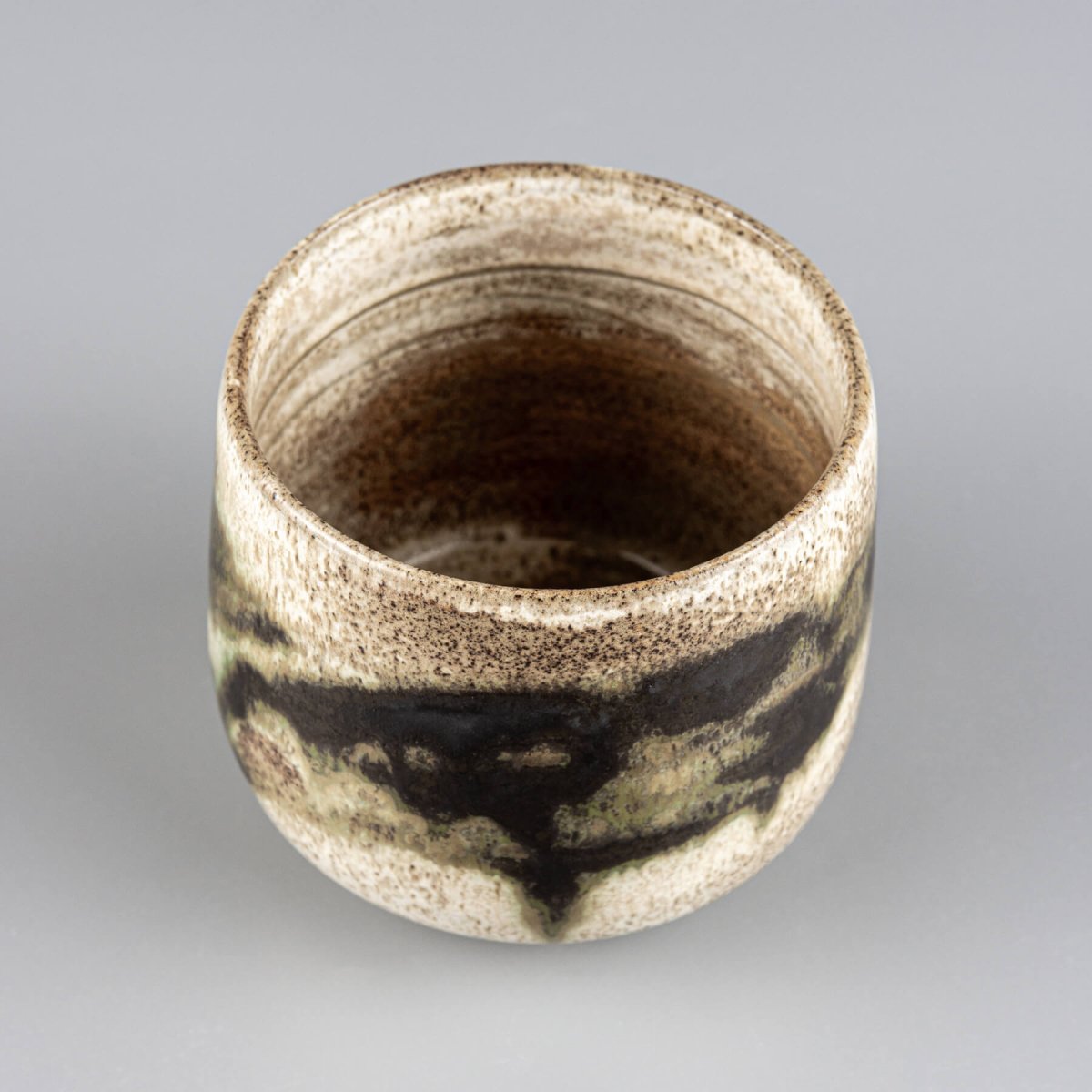 Collectible pottery mug crafted from dark stoneware clay for fine dining settings.