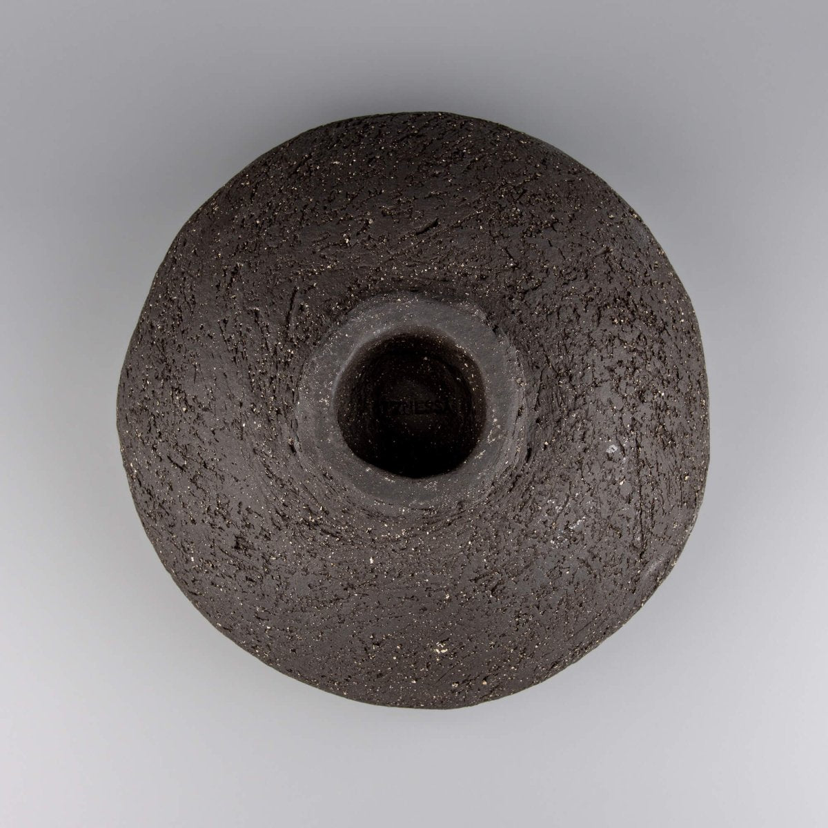 Handcrafted centerpiece underside with raised foot and raw texture for collectible pottery displays.