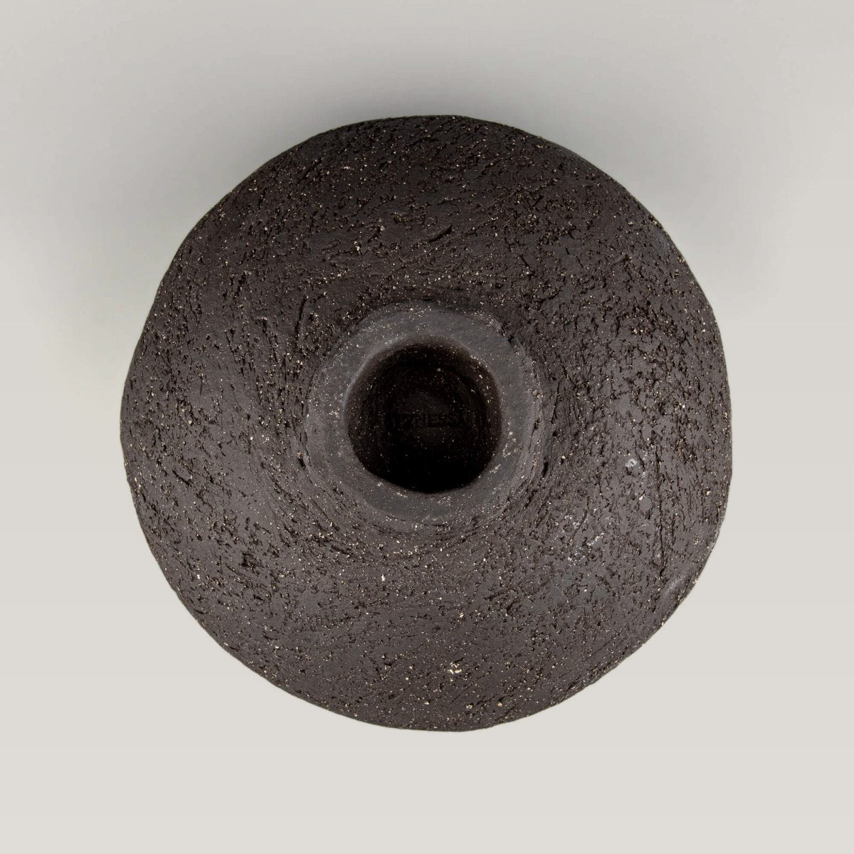 Handcrafted centerpiece underside with raised foot and raw texture for collectible pottery displays.