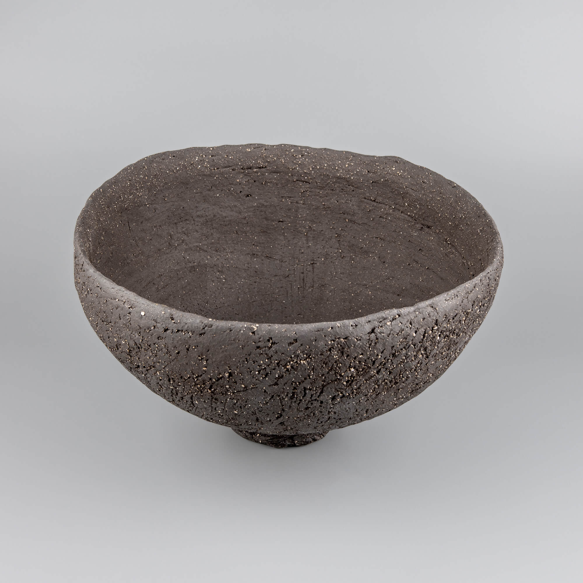 Handcrafted centerpiece side view with deep ceramic form for collectible pottery and fine dining decor.