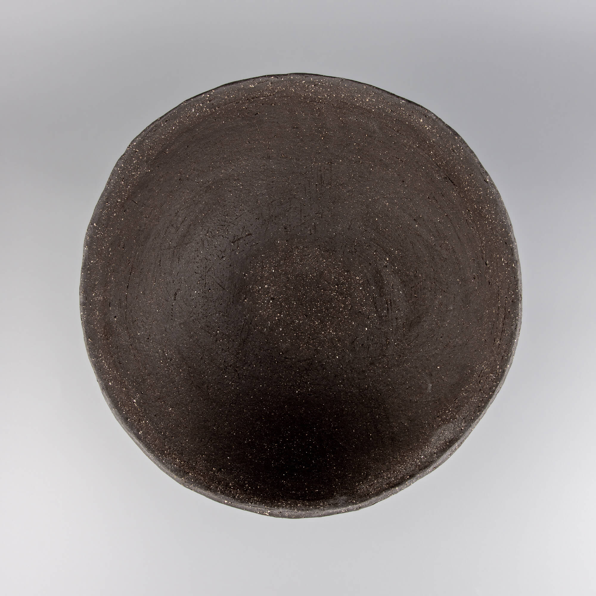 Handcrafted centerpiece top view showing dark ceramic interior for luxury tableware and home styling.