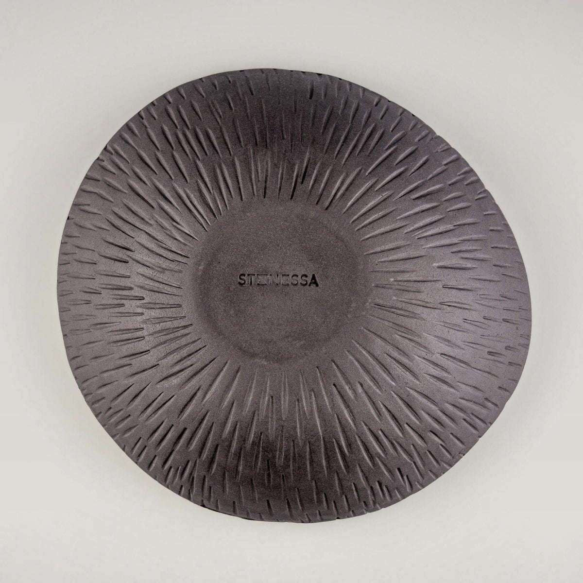 Bottom view of a handmade ceramic bowl with a carved exterior, suitable for luxury tableware and boutique hotel use.