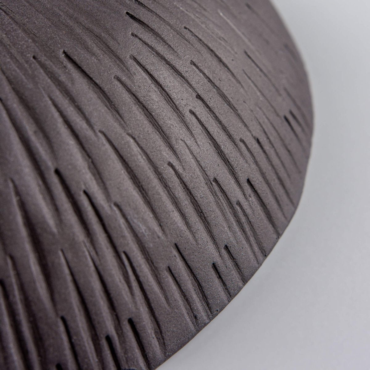 Detail of handmade ceramic bowl rim and glaze texture, emphasizing artisan craftsmanship and collectible pottery quality.