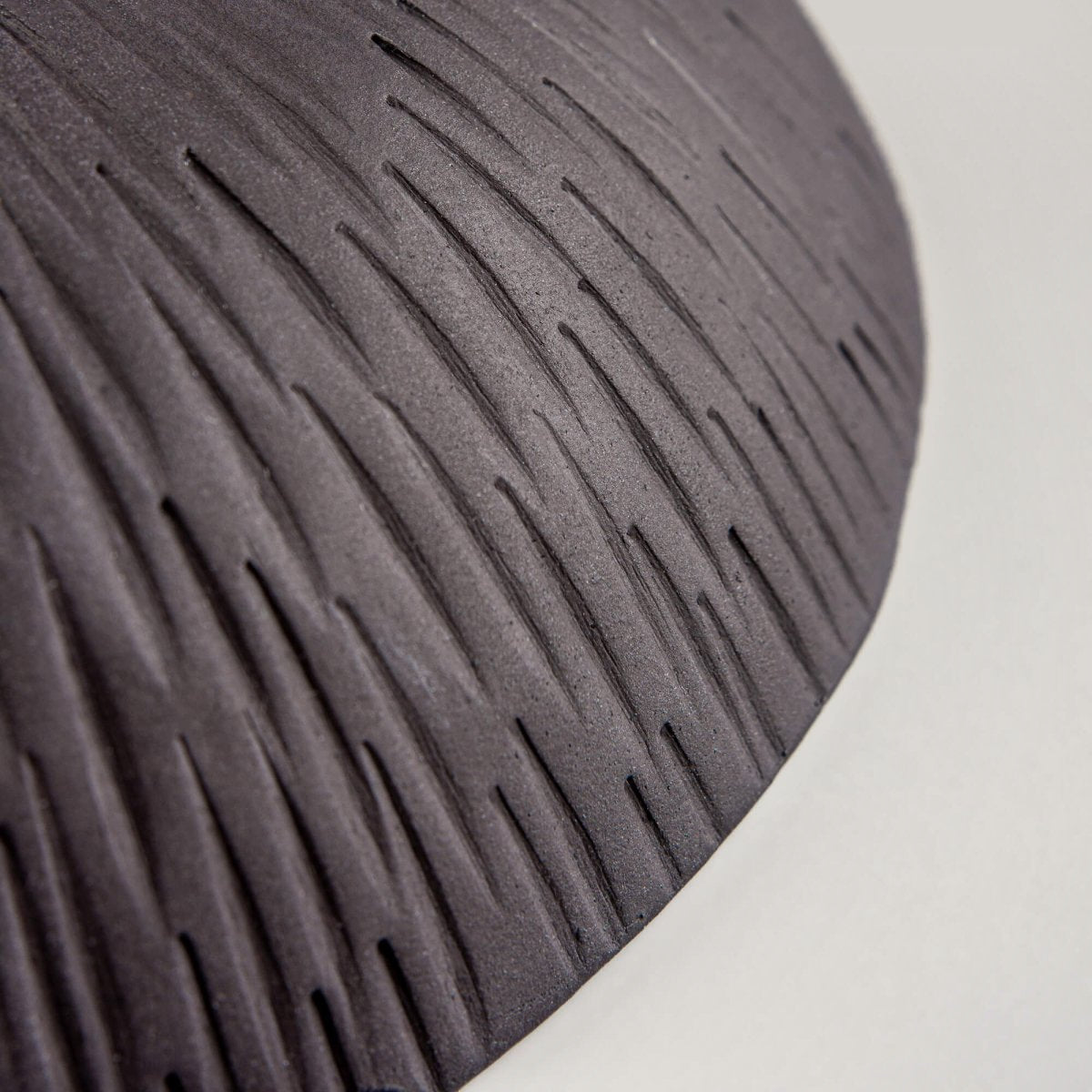 Detail of handmade ceramic bowl rim and glaze texture, emphasizing artisan craftsmanship and collectible pottery quality.