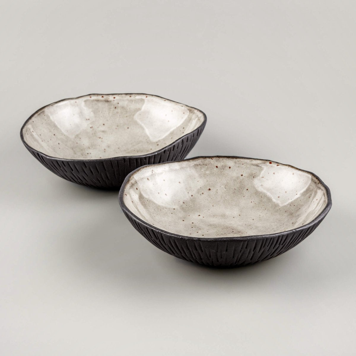 Set of handmade ceramic bowls arranged for fine dining service in upscale restaurant and culinary environments.