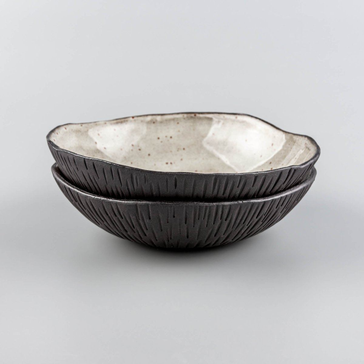 Stacked handmade ceramic bowls displaying consistent form and premium craftsmanship for professional kitchenware.