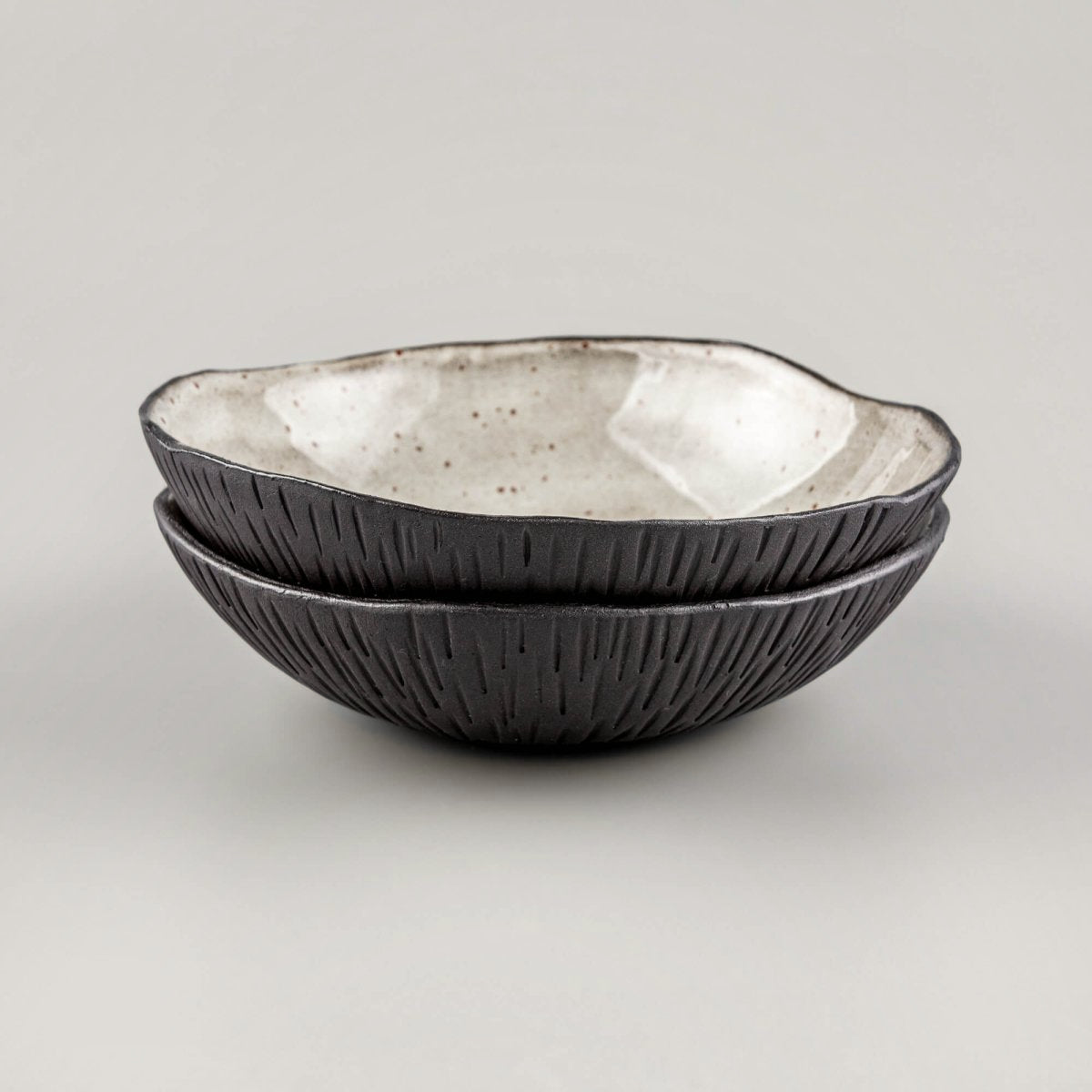 Stacked handmade ceramic bowls displaying consistent form and premium craftsmanship for professional kitchenware.