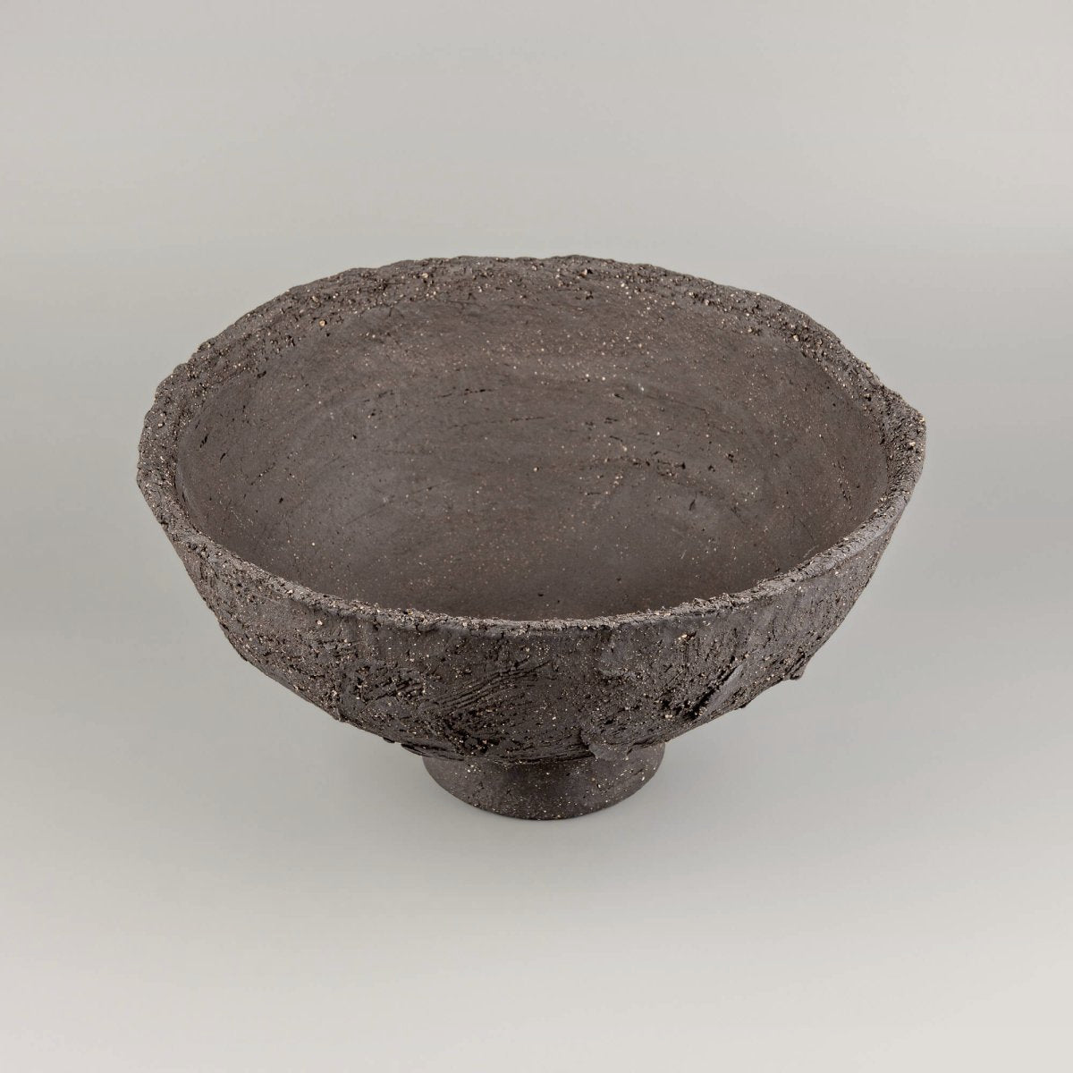 Handmade decorative bowl with deep charcoal clay texture, wide open shape, and centerpiece appeal for home or hotel decor.