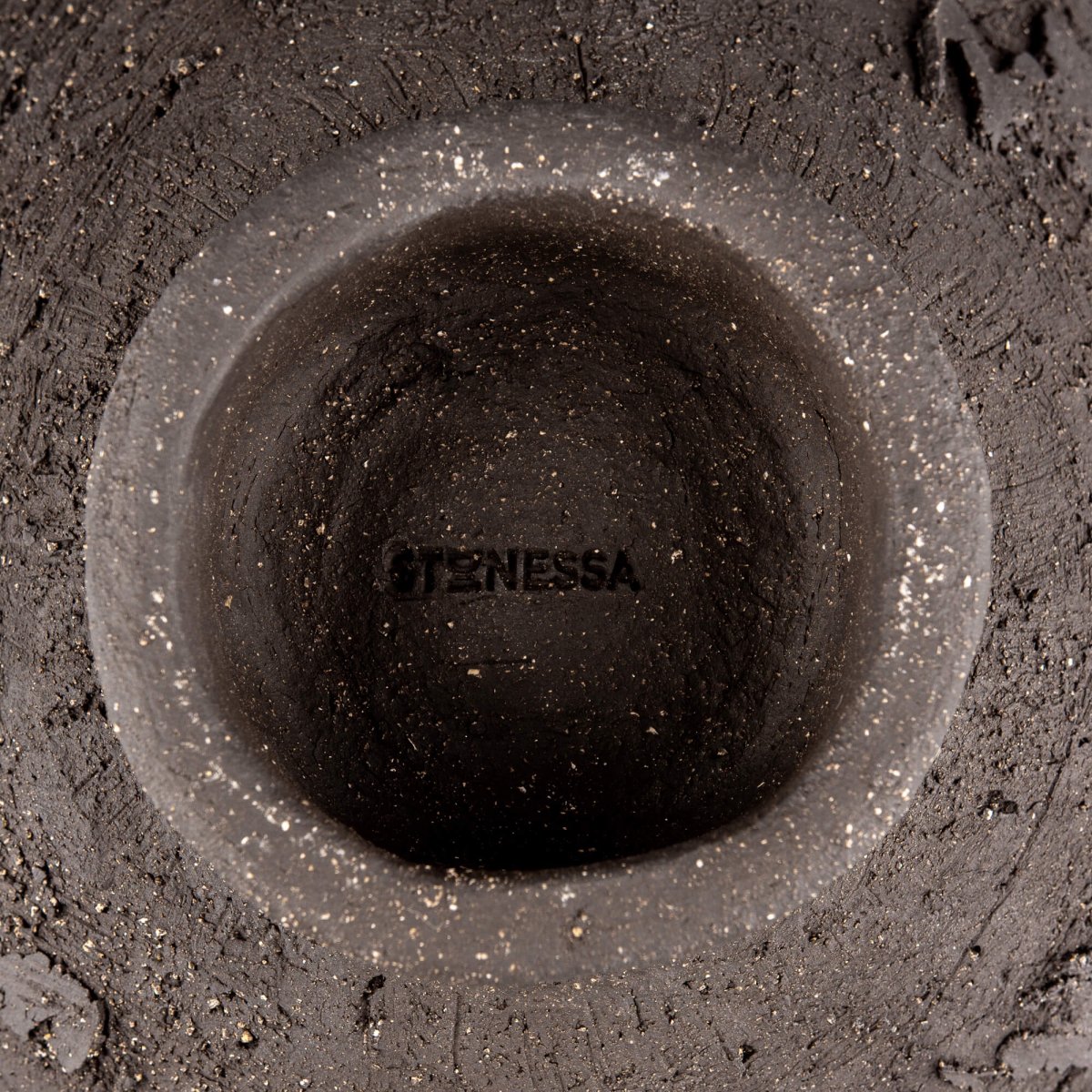 Handmade decorative bowl base detail with dark speckled stoneware, sculptural foot, and handmade ceramic surface.