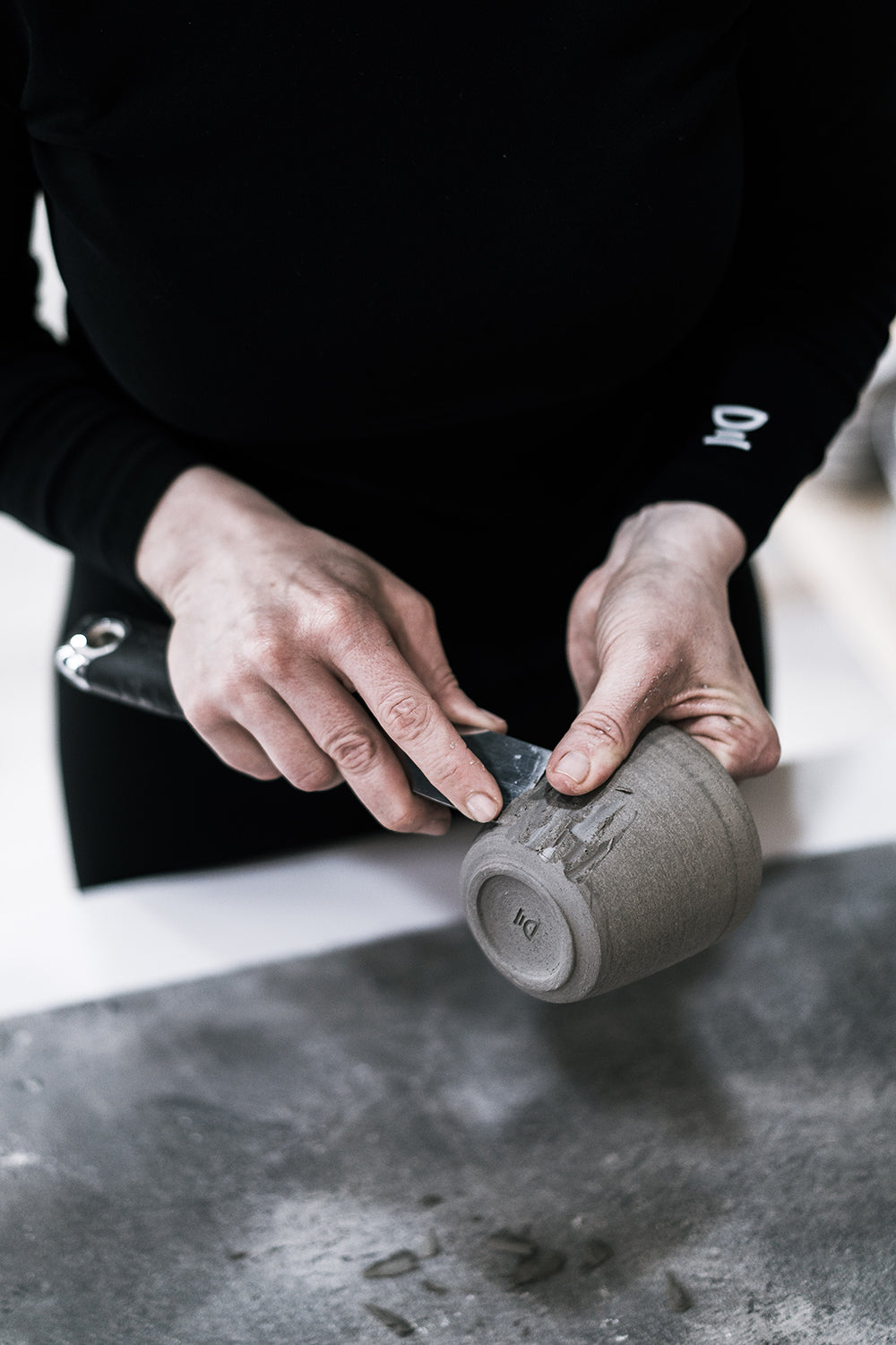 Artist handcrafting a ceramic cup - Stonessa Pottery.