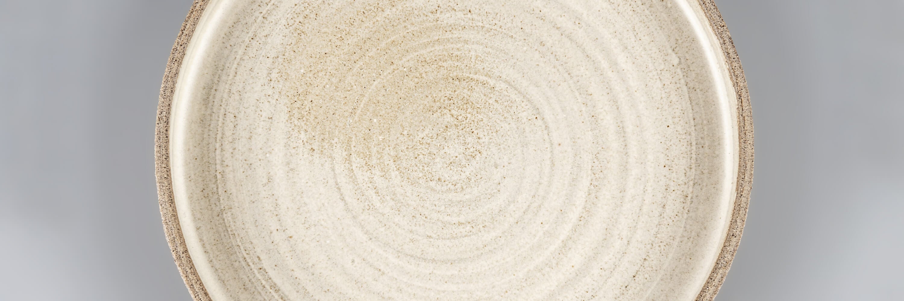 Close-up of handmade ceramic plate in artisanal stoneware, luxury dinnerware crafted for fine dining and master chefs by Stonessa.