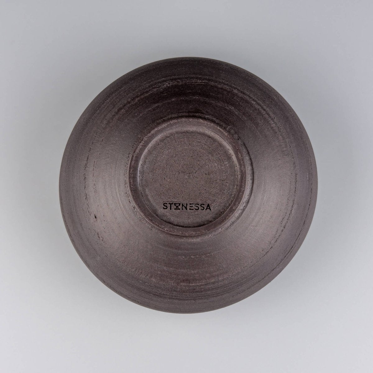 Flat overhead view of ceramic bowl with unique glaze effect and soft circular foot.