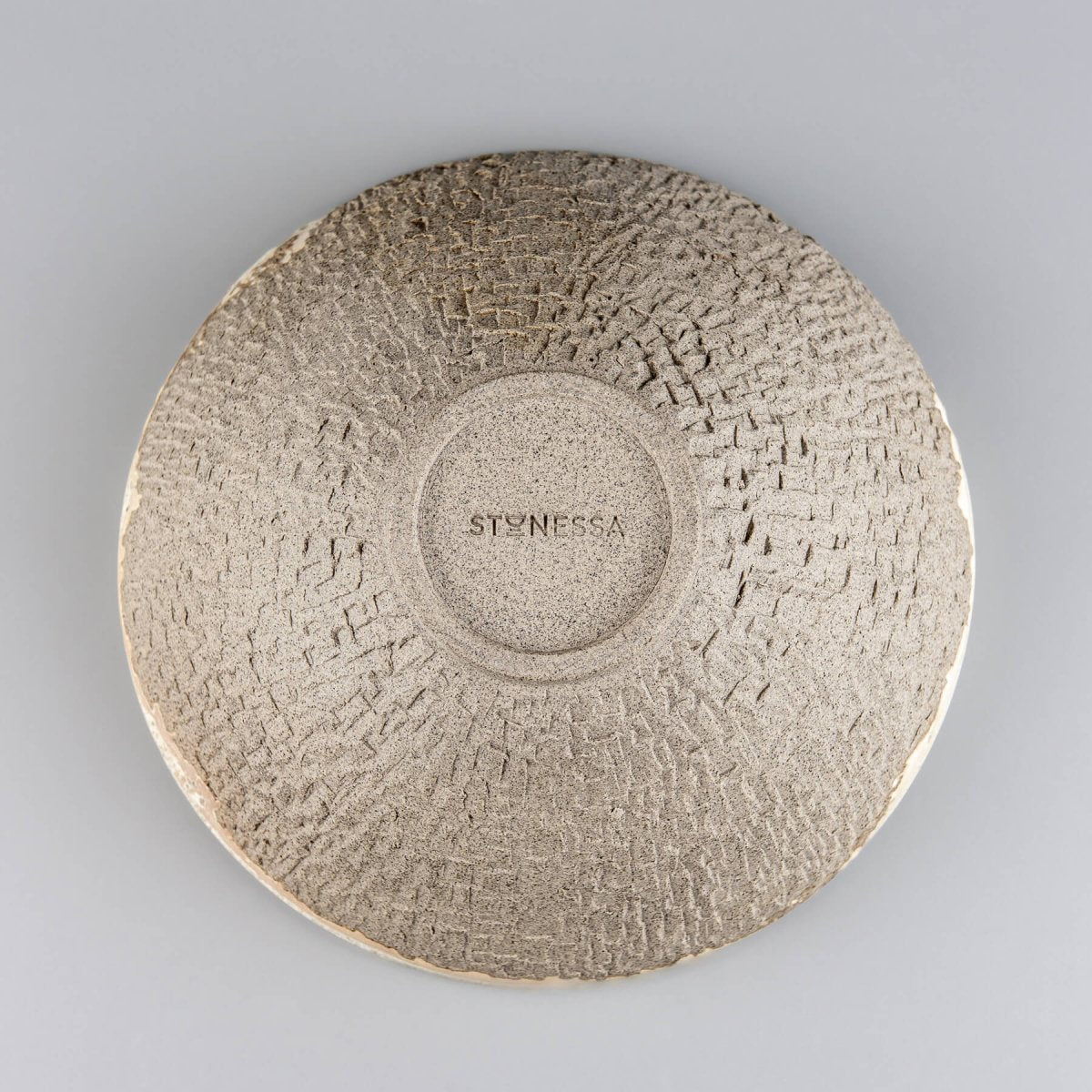Bottom view of artisan stoneware bowl with handmade signature and circular foot ring.