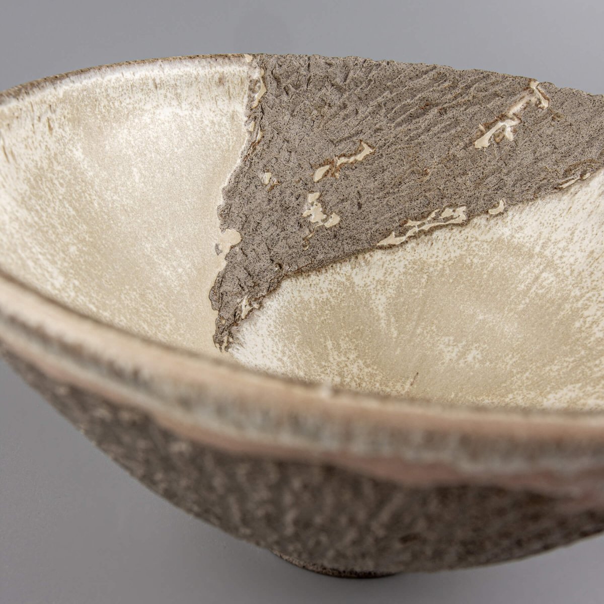Rustic modern handmade decorative bowl in stoneware, ideal for interior design and collectible pottery.