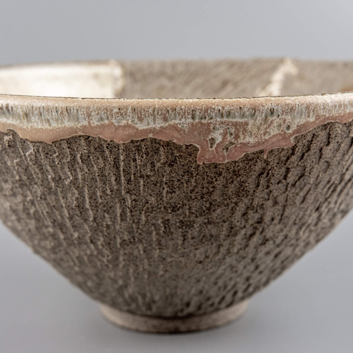 Close-up of bowl texture showing hand-carved detail and organic matte glaze transition.