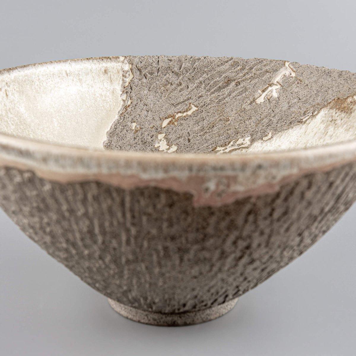 Detail of unglazed textured surface emphasizing artisanal carving and ceramic craftsmanship.