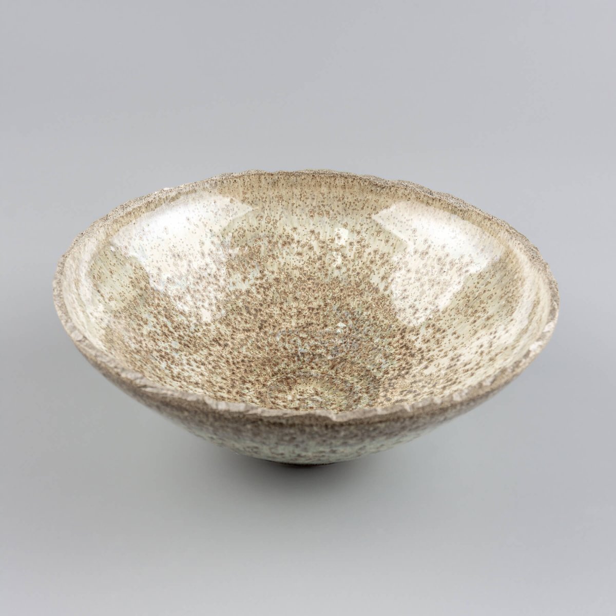 Side view of handcrafted ceramic bowl in stoneware with smooth glaze and modern silhouette.