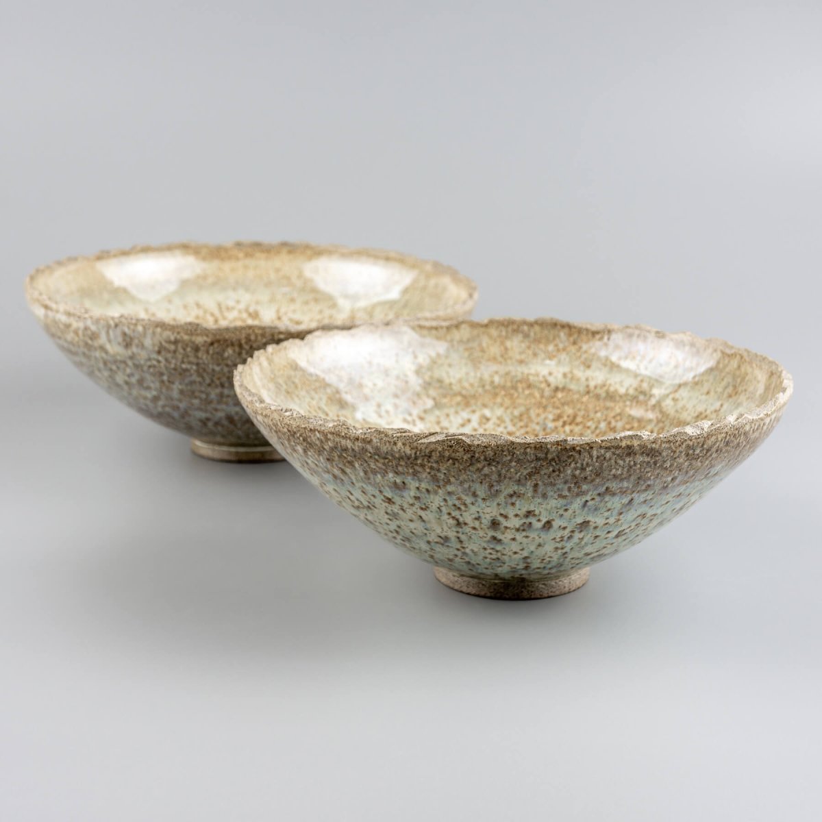Set of artisan ceramic bowls with natural glaze, perfect for rustic interior decor or functional use.