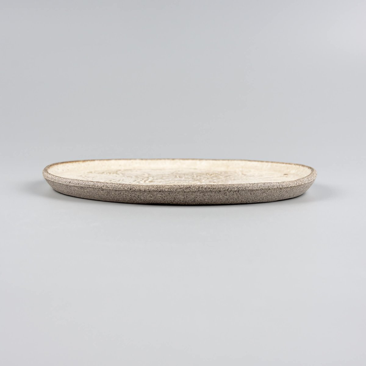 Chef holding small artisan plate, perfect for culinary presentation or restaurant use.