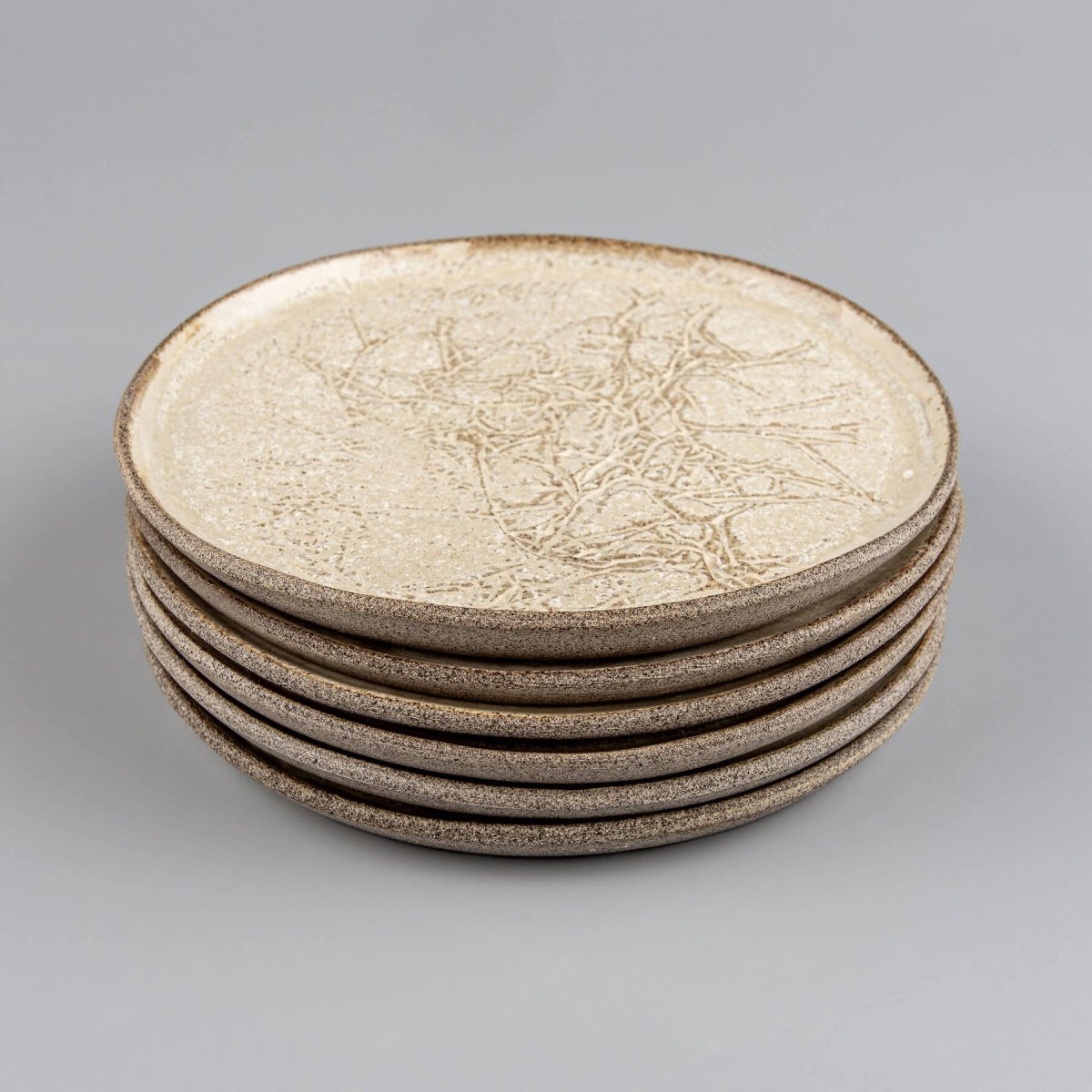 Stoneware plates stacked for kitchenware or collectible pottery display.