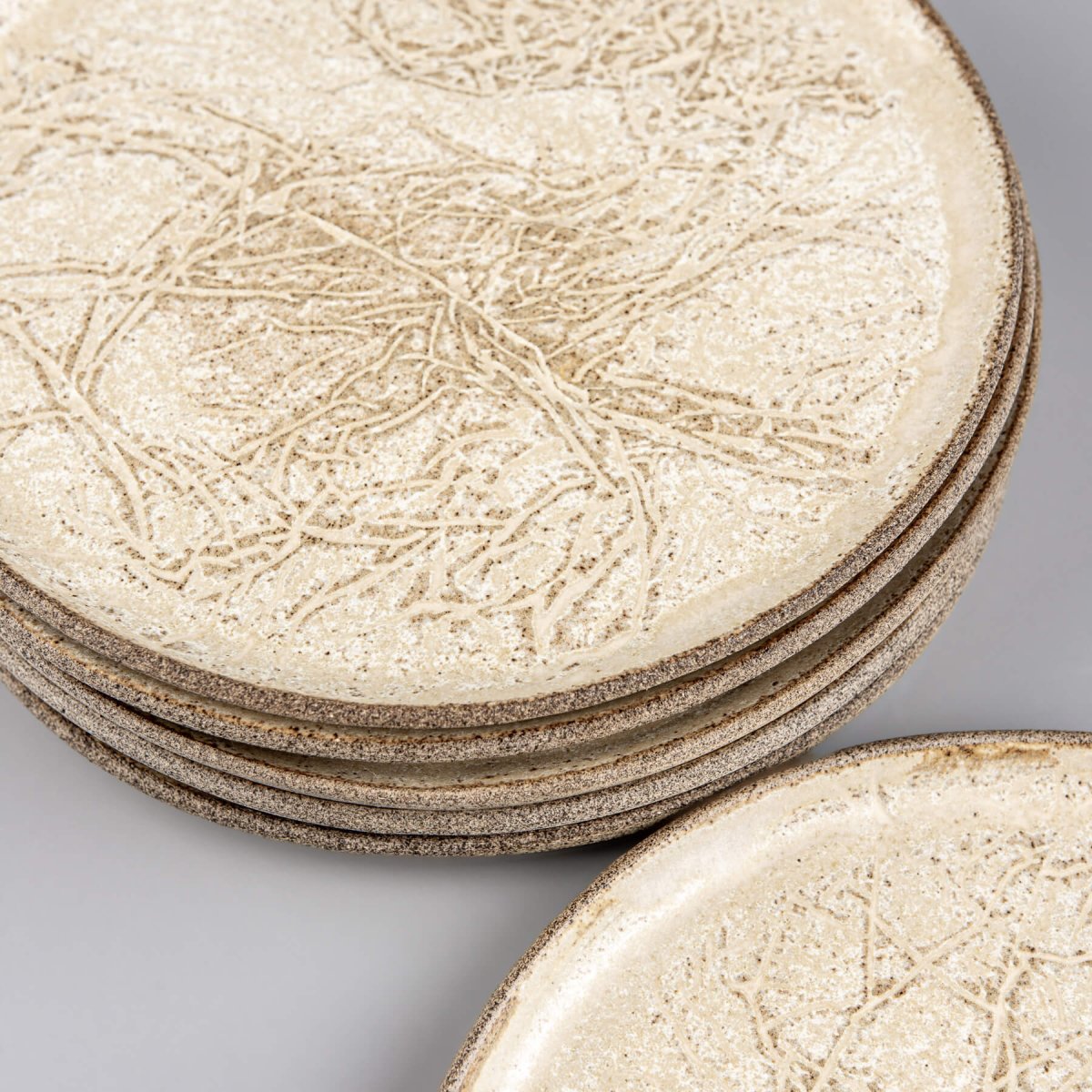 Stoneware plates stacked for kitchenware or collectible pottery display.