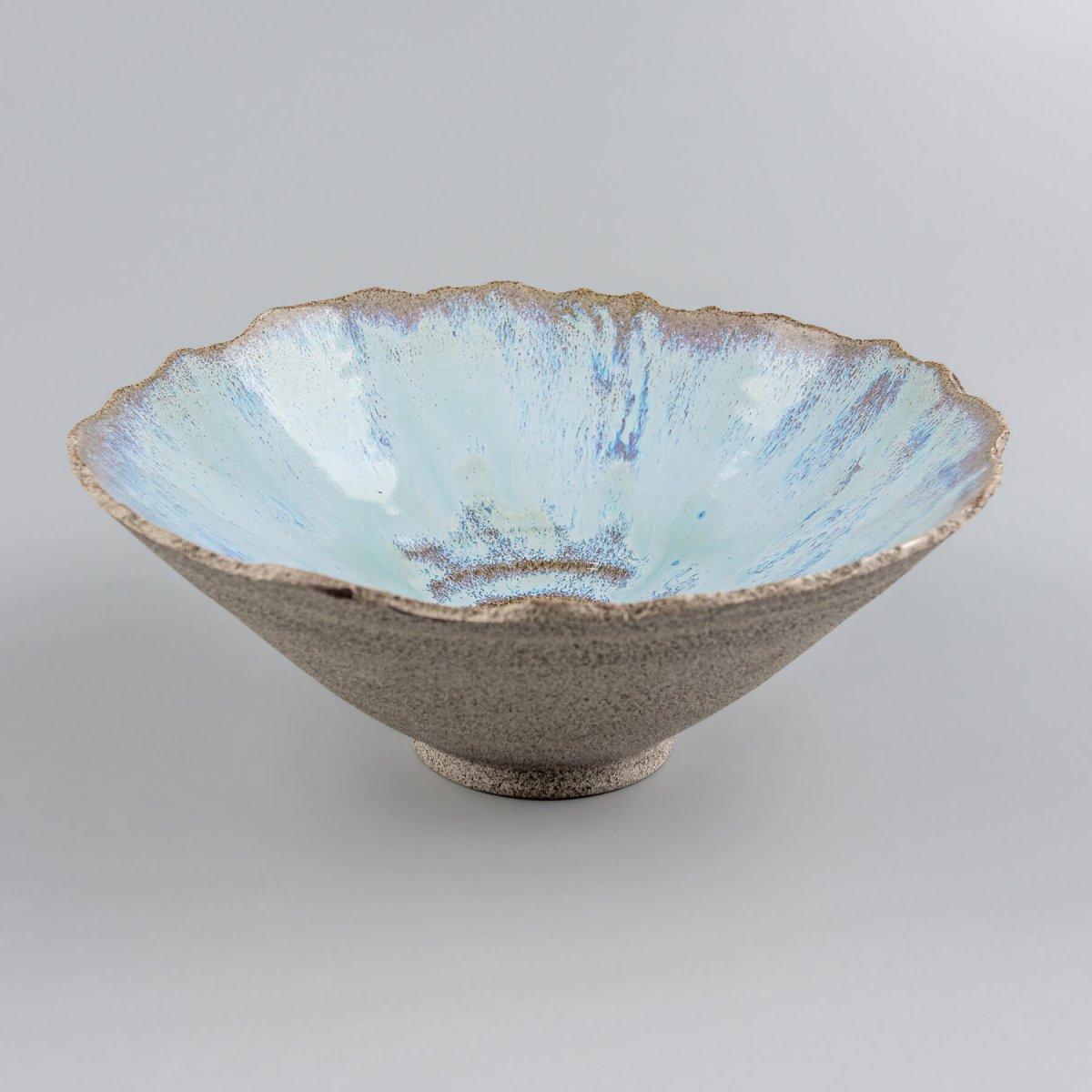 Front perspective of handcrafted stoneware serving bowl highlighting glazed interior.