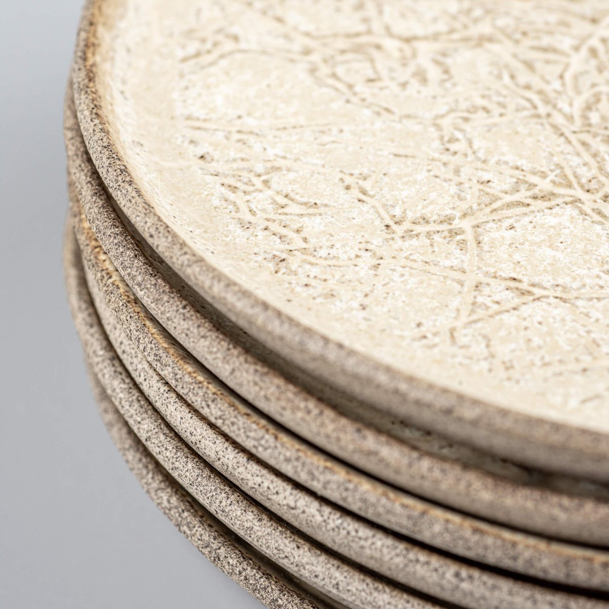 Detail of hand-textured matte ceramic plate used in boutique settings.