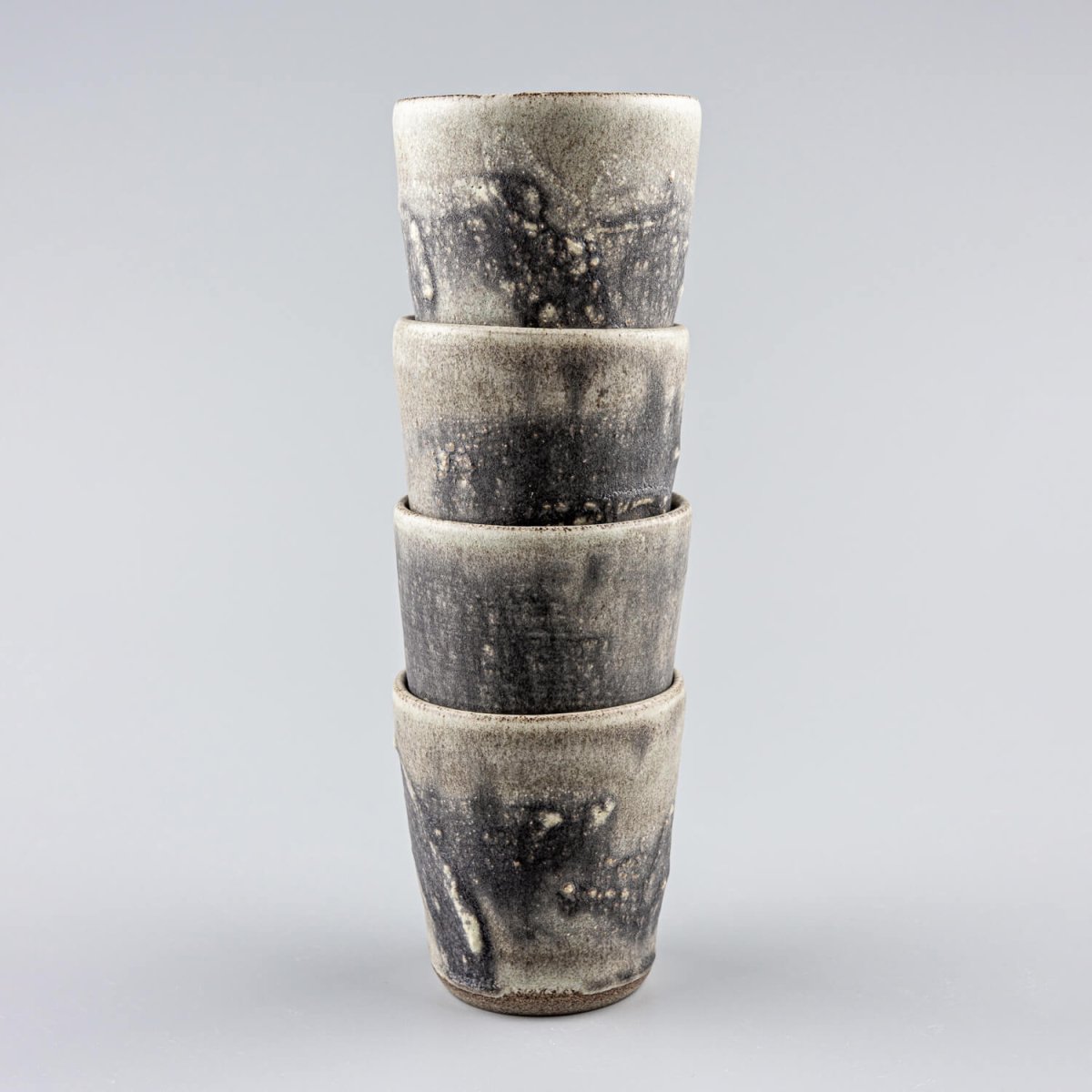 Unique handmade pottery cups with a flat base and artistic glaze, ideal for fine dining restaurants and boutique hotels.