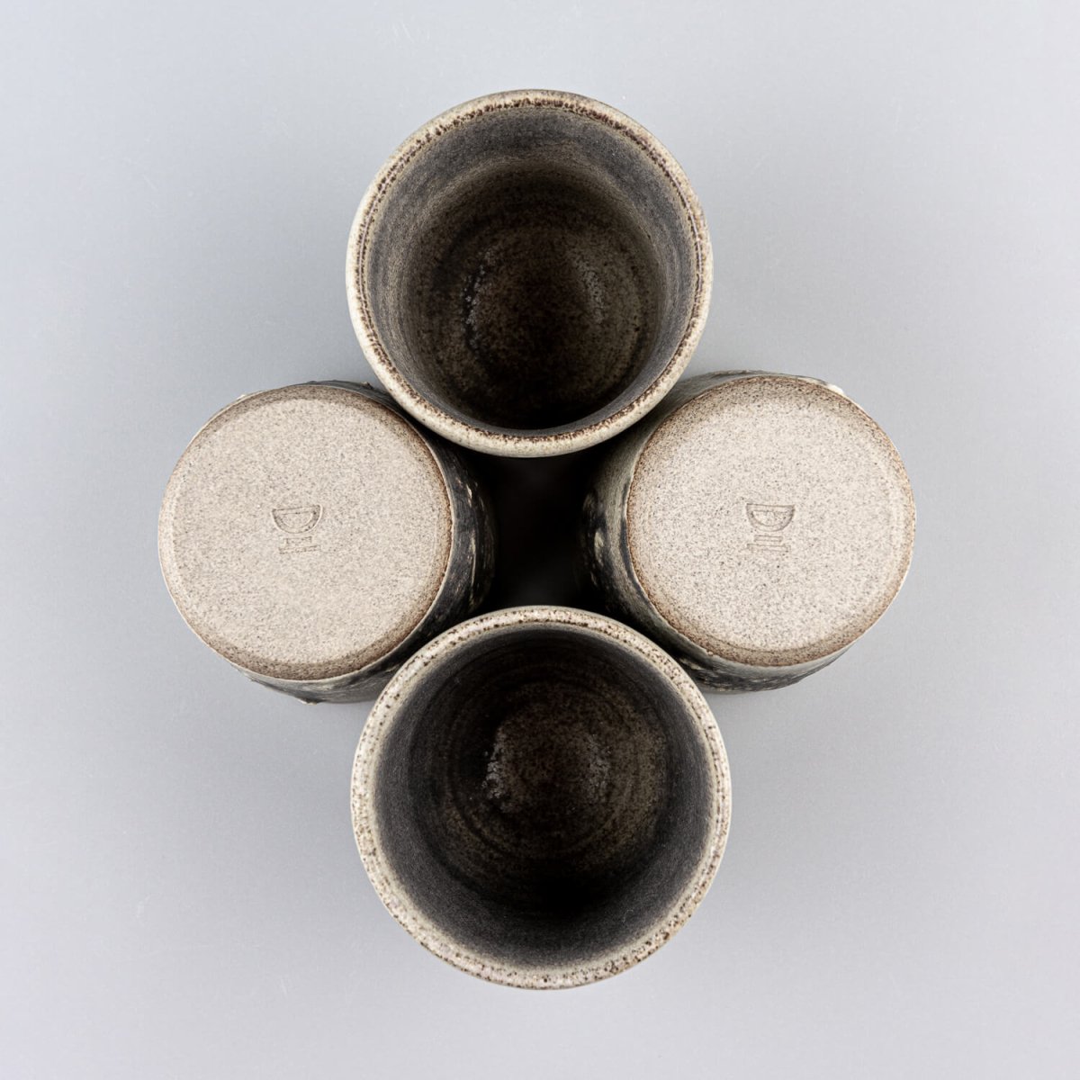 Top view of pottery cups set showing rustic interior glaze and functional design for home and restaurant use.