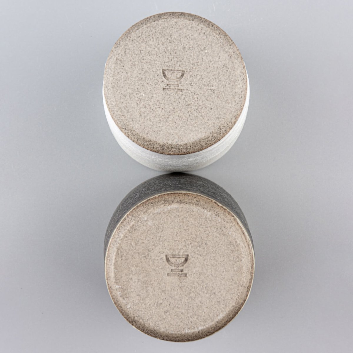 Base detail of handmade ceramic cups, showcasing artisanal craftsmanship and collectible pottery.