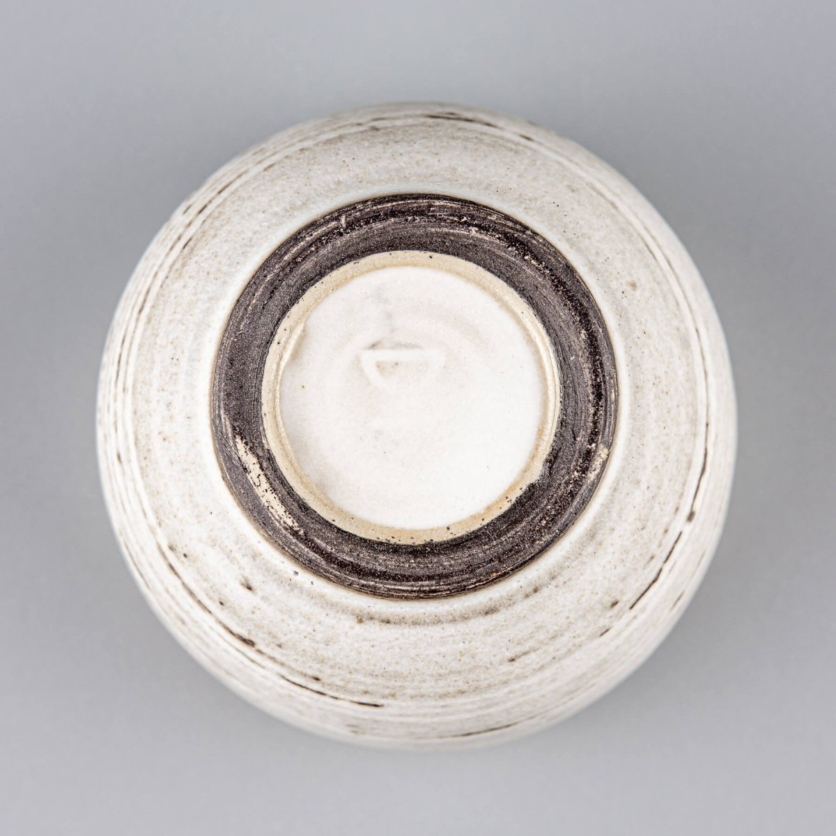 Handmade ceramic mug with white glaze and dark clay base, ideal for home, restaurant, and kitchenware use.