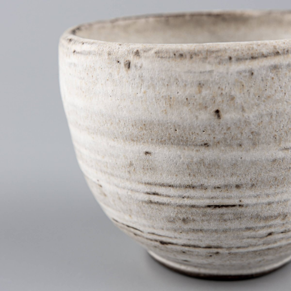 Unique stoneware mug with soft matte surface, blending functional tableware and collectible pottery.