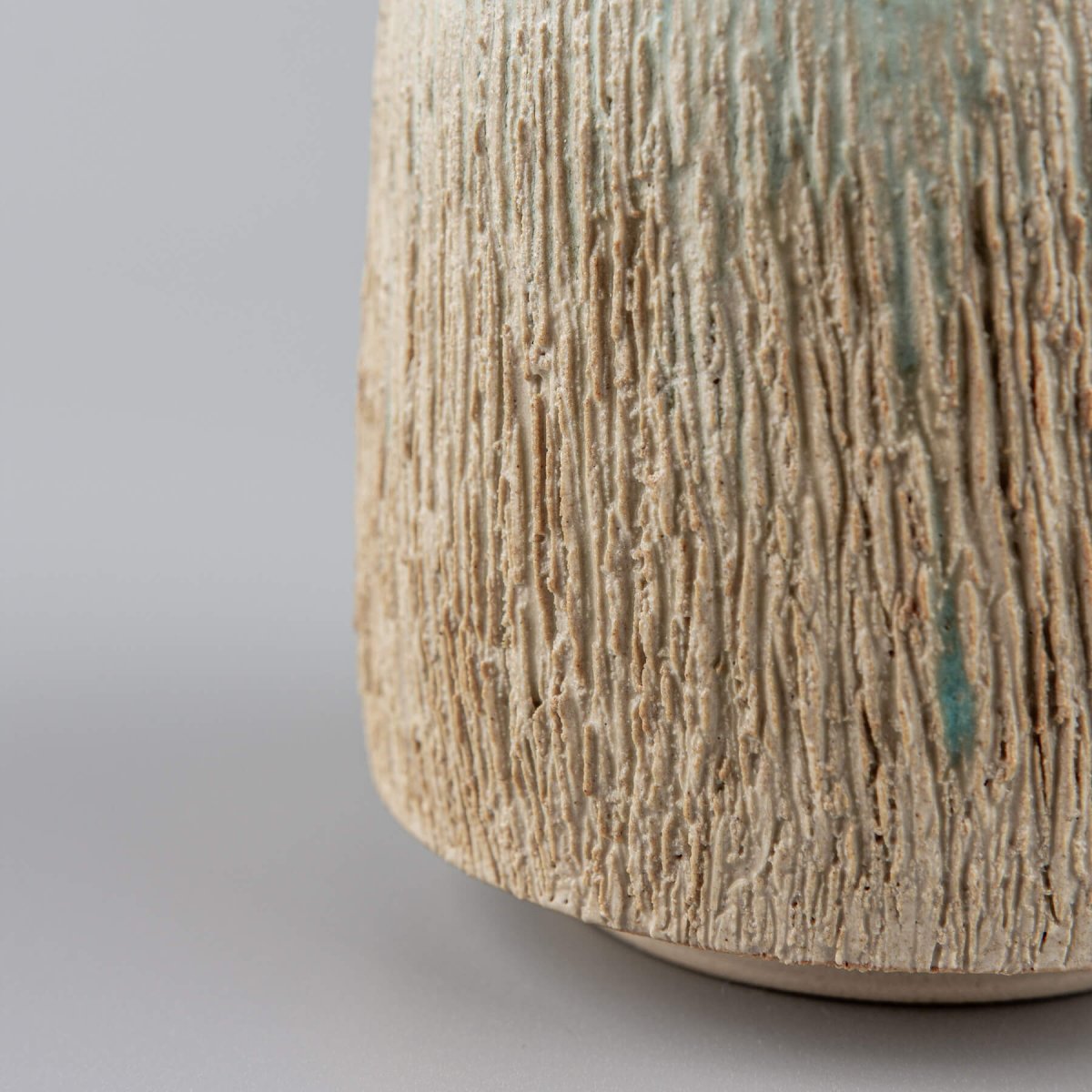 Elegant handmade pottery mug with rustic carving and aqua glaze, perfect as a wedding gift.