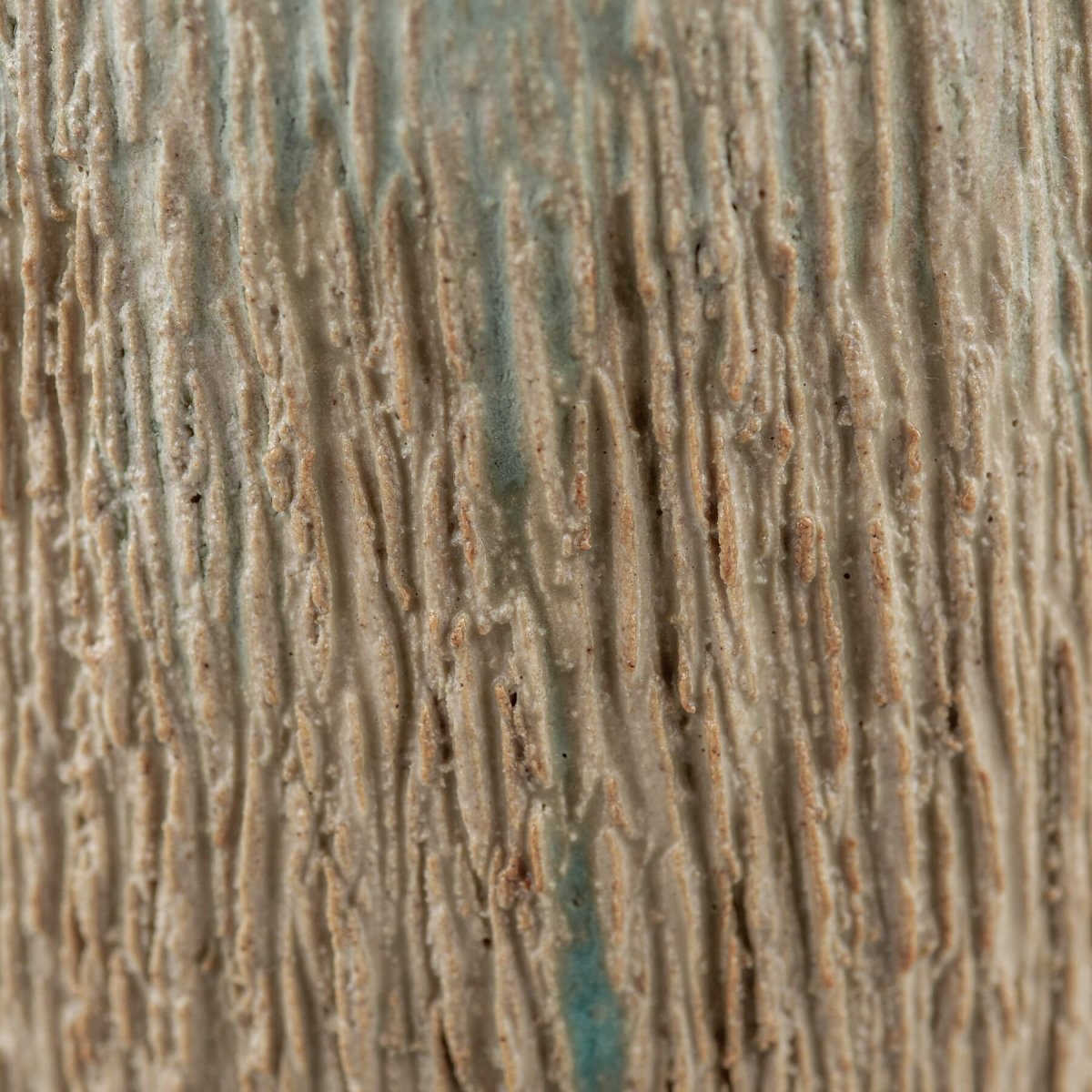 Artisanal pottery cup with natural clay texture and aqua interior, housewarming gift idea.