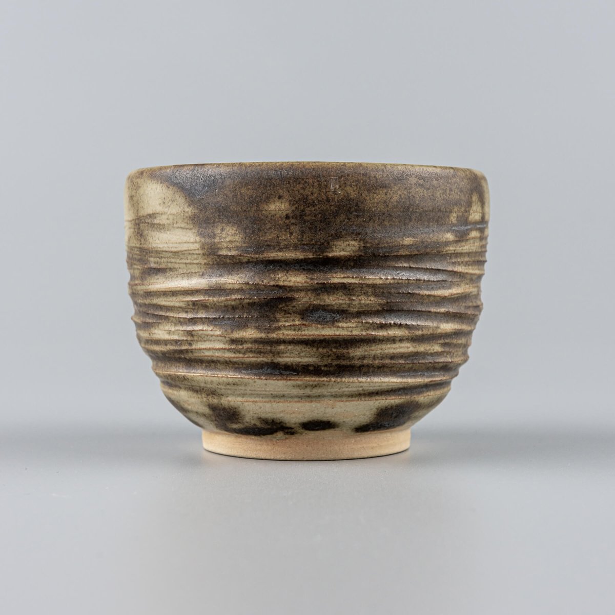 Handmade ceramic mug with earthy olive glaze and carved texture, ideal for coffee, tea, fine dining, and hotel tableware.