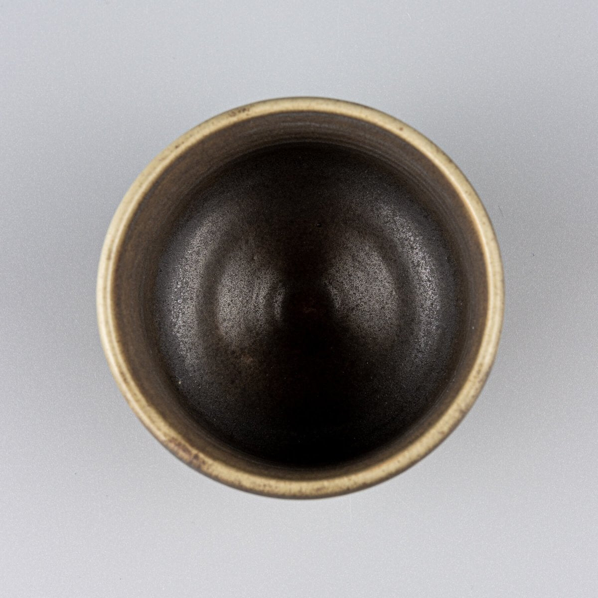 Top view of handmade ceramic mug with dark interior glaze, designed for fine dining restaurants and private collectors.
